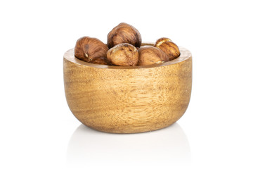 Lot of whole tasty brown hazelnut in bamboo bowl isolated on white background