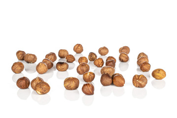 Lot of whole disordered tasty brown hazelnut isolated on white background