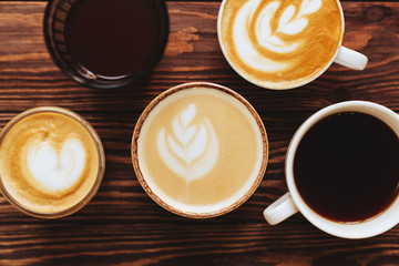 five cups of coffee on vintage wood. Top view , cup on wooden table. View from top