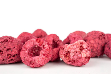 Lot of whole bright dried raspberry closeup isolated on white background