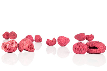 Lot of whole disordered dried raspberry isolated on white background