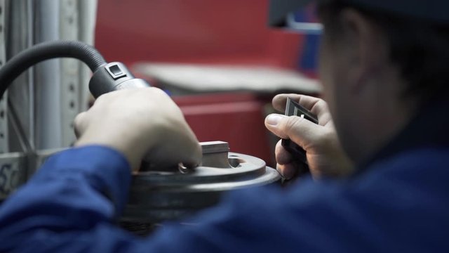 Engineer checks quality die for aluminium metal profiles production. Production of Complex lightweight extruded aluminium metal profiles, commonly used as material in construction and manufacturing