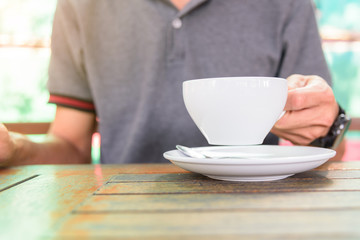 The man take the hot coffee to drink