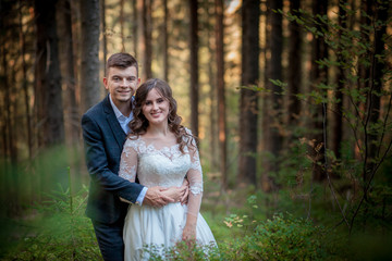Bride and groom in forest on their wedding, photo session.
