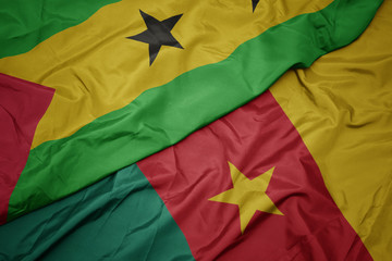 waving colorful flag of cameroon and national flag of sao tome and principe .
