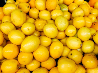 lots of yellow sour lemons to eat as a background