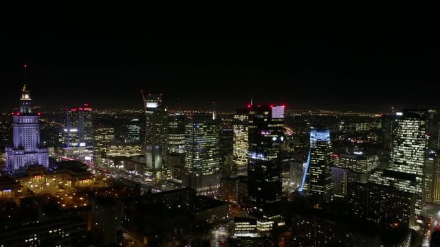Aerial view of skyscrapers and buildings in Warsaw City skyline,  night light in the winter. Poland.  04. December. 2019. View of the night skyscrapers and streets in the business center of the city. 