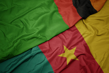 waving colorful flag of cameroon and national flag of zambia.