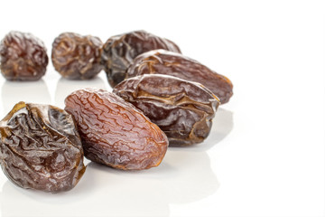 Group of seven whole dried brown date fruit half circle isolated on white background