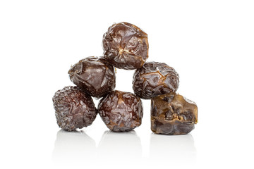 Group of six whole dried brown date fruit heap isolated on white background