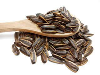Sunflower seeds pile in spoon isolated on white background. Roasted and Salted in the original flavor.Great nutritous and rich with oil which makes it a high energy source. Snack for diet and healthy.