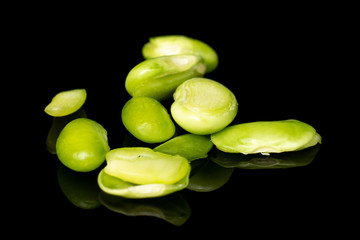 Lot of pieces of snap green bean isolated on black glass