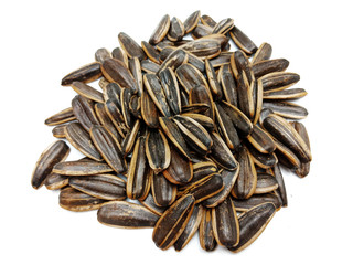 Sunflower seeds pile against isolated on white background. Roasted and Salted in the original flavor. Great nutritous and rich with oil which makes it a high energy source. Snack for diet and healthy.