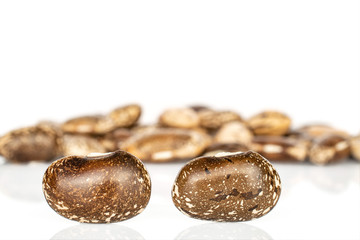 Lot of whole dried speckled brown bean pinto isolated on white background