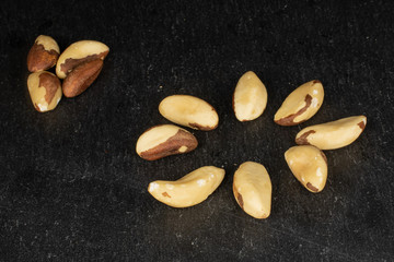 Lot of whole brazil brown nut on grey stone