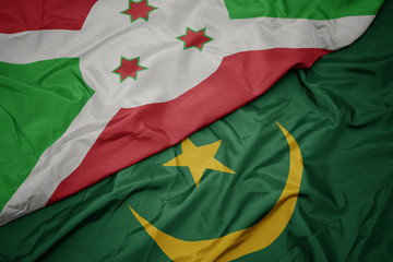 waving colorful flag of mauritania and national flag of burundi .