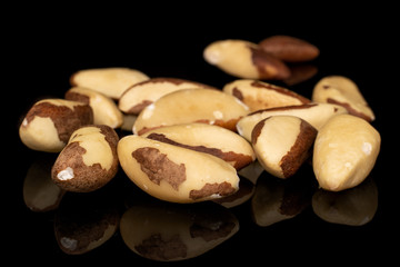Lot of whole brazil brown nut isolated on black glass