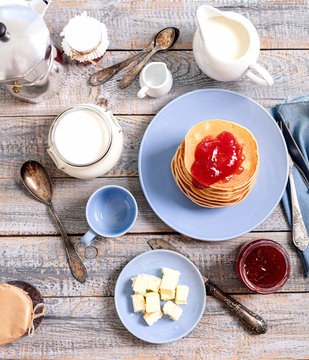 Tasty breakfast. Pancakes with strawberry confiture and butter.