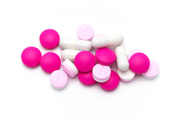 Prescription drugs, pills, capsules and tablets of different colors all mixed in. On white background.