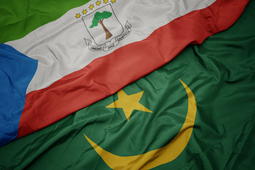 waving colorful flag of mauritania and national flag of equatorial guinea.