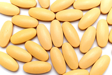 Group of Vitamin C pills top view on white background.