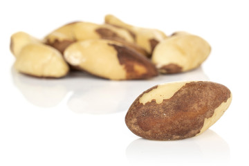 Lot of whole brazil brown nut front focus isolated on white background