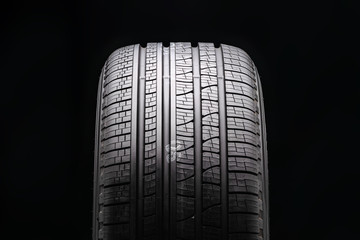 new black all-season premium tire. protector close-up. front view. © Vladimir Razgulyaev