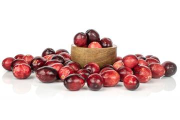 Lot of whole fresh red cranberry in bamboo bowl isolated on white background