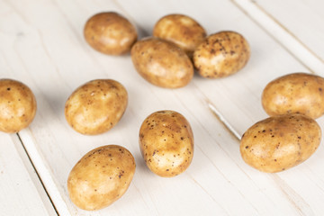 Lot of whole tiramisu brown almond nut on white wood