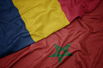 waving colorful flag of morocco and national flag of chad.