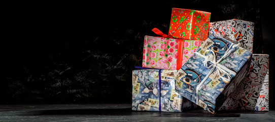 Christmas gift boxes on dark background. Luxury new year gift. Christmas background with gift box