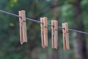 clothespins hanging on a rope dripping with water,