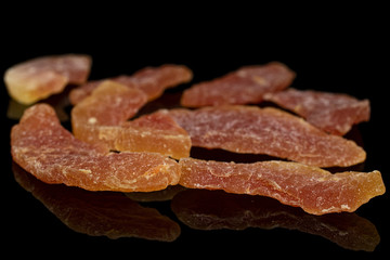 Lot of whole dried orange papaya piece isolated on black glass