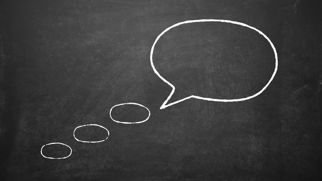 Chalk written on the blackboard inside the cloud speech bubble word IDEA