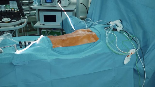 Human body soaked with iodine lying on operating table