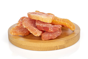 Group of six whole dried orange papaya piece on round bamboo coaster isolated on white background