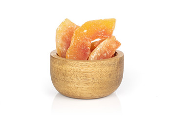 Lot of whole dried orange papaya piece in bamboo bowl isolated on white background