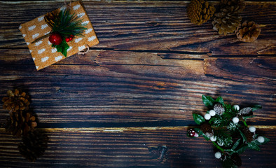 Christmas decorations on wooden background, pine cones and ivy