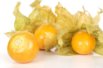 Group of three whole fresh orange physalis isolated on white background