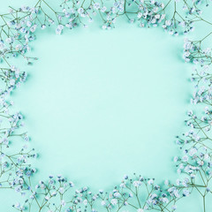 Beautiful flower frame of blue gypsophila flowers. Flat lay, top view. Floral pattern.