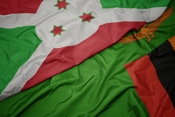 waving colorful flag of zambia and national flag of burundi .