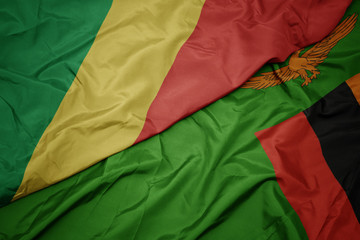 waving colorful flag of zambia and national flag of republic of the congo.