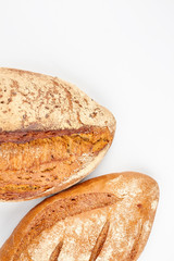 Rye bread isolated on white background. Two loaves of fresh organic bread. Space for text.