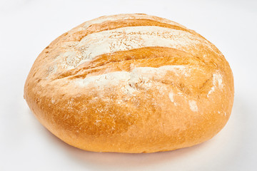 Loaf of fresh bread on white background. Delicious wheat bread. Easy artisan bread recipe.