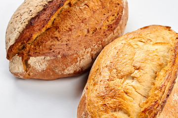 Fresh crusty bread on white background. Gluten free artisan bread. Homemade food for breakfast.