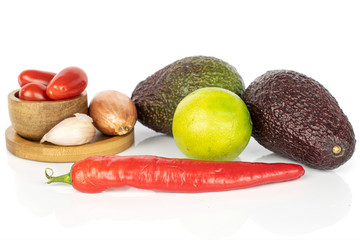 Lot of whole ingredient guacamole on round bamboo coaster in bamboo bowl isolated on white background