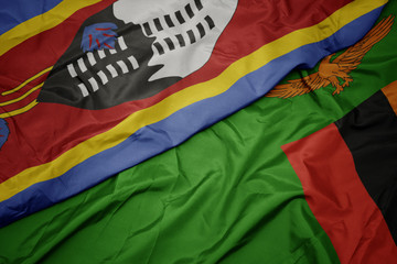 waving colorful flag of zambia and national flag of swaziland.