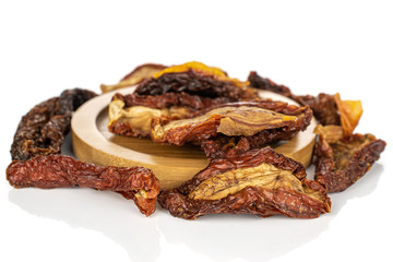 Lot of whole arranged dried red tomato piece on round bamboo coaster isolated on white background