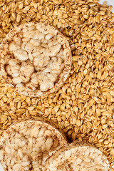 Oatmeal crispbread and oat flakes background. Oatmeal crunchy bread and oatmeal flakes close up.