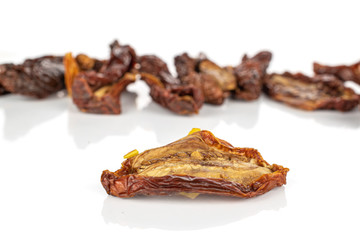 Group of eight whole dried red tomato piece isolated on white background